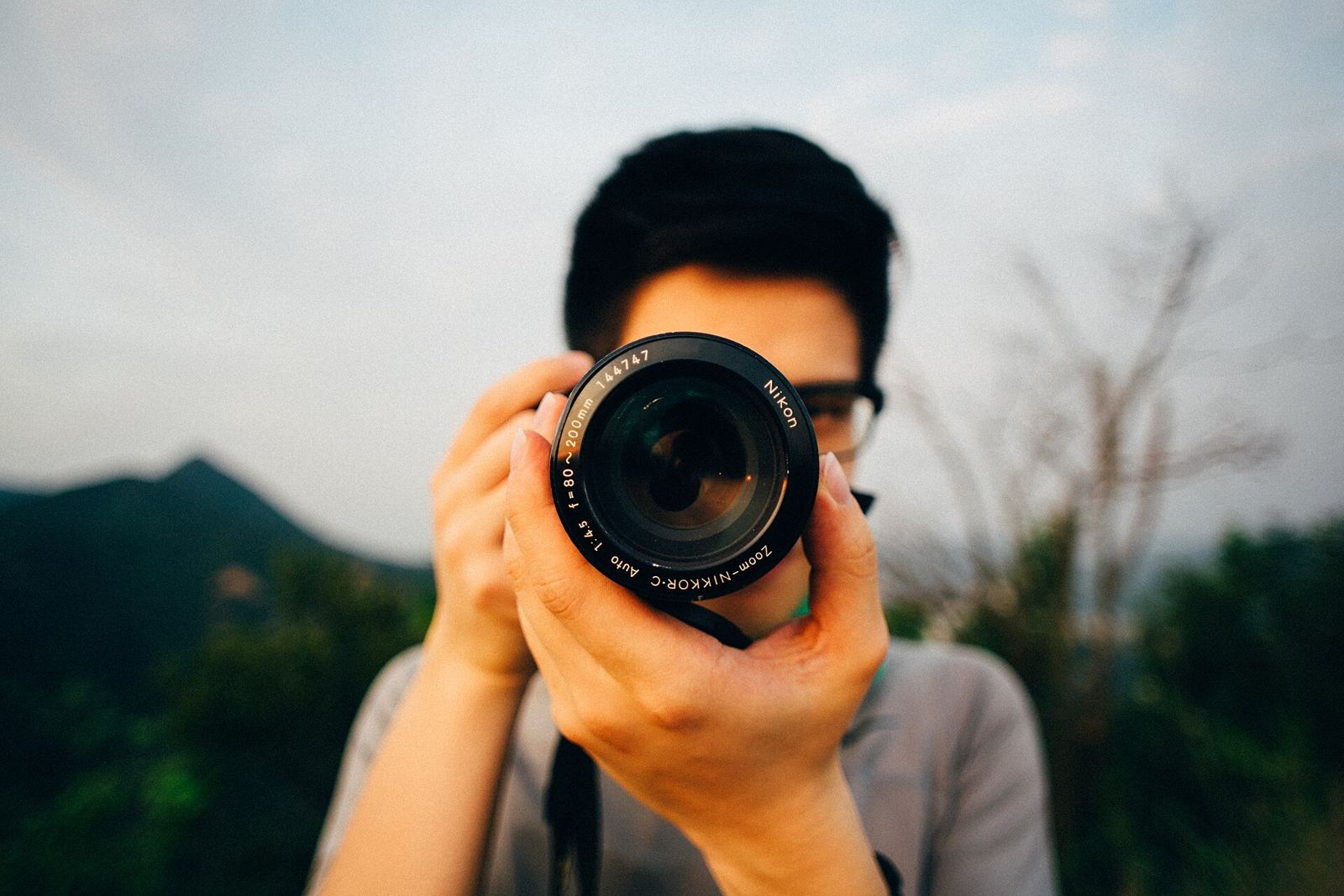 Photographer focusing a camera lens